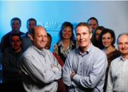 Executive vice presidents (l-r) Jeff Adler, chief property operations officer, and Tim Beaudin, chief development officer, have worked closely with their team members (pictured here) to develop a strategy that will help the Denver-based firm through tough times.