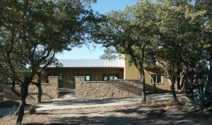 This 5-Star-rated ranch-style house from Wm T Moore Construction was constructed with Perform Wall ICFs that use 85% waste styrofoam and 15% cement to make a 10-inch wall that accepts cement stucco without metal lath or expansion joints. Other features include a SIPs roof system, metal roofing and a pitch optimized for future PV additions, and geothermal HVAC. The house is designed to capture breezes and be shaded the summer sun, while the front courtyard protects the herb gardens from deer.