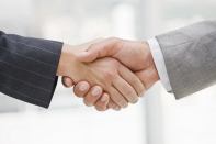 Business people joining hands together for deal