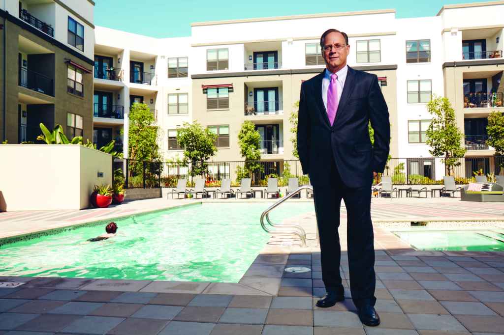 Mike Schall stands on the grounds of Radius Apartments in Redwood City, Calif. The development is one of the properties Essex acquired in its purchase of BRE last year.