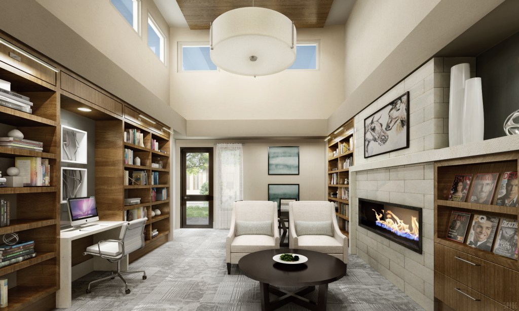 The building's inviting library features a computer station, a fireplace, and comfortable seating.