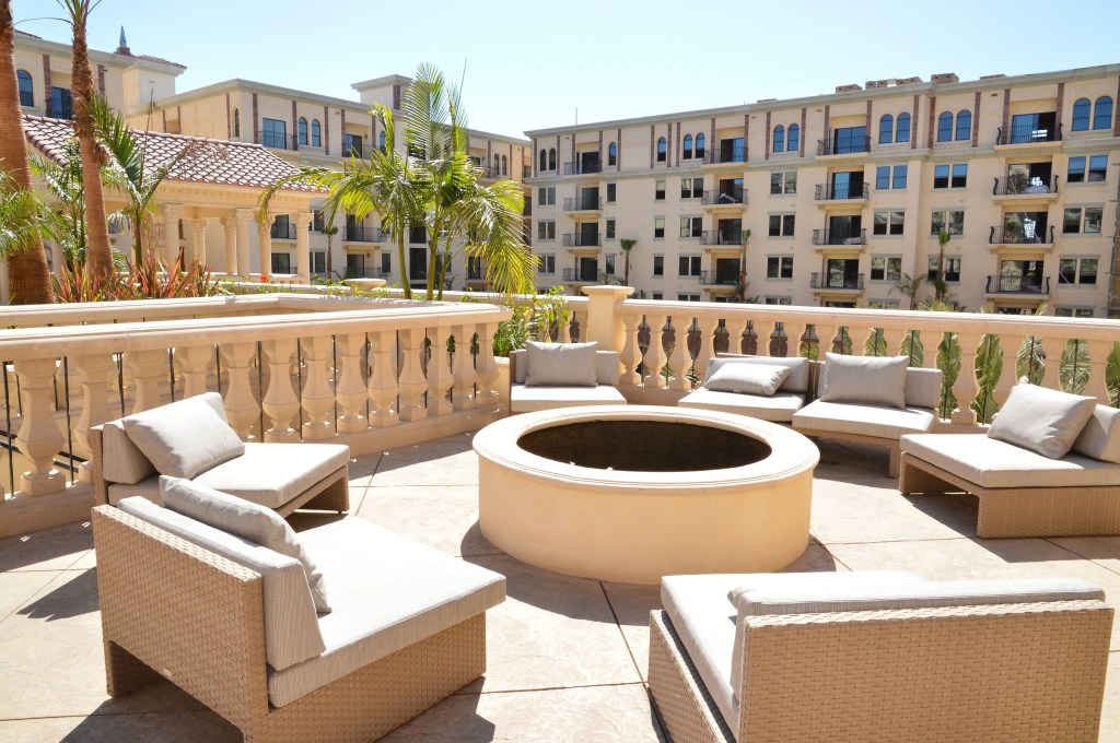 A terrace with fire pit among Lorenzo's Italianate-style exteriors.