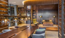 Common areas at Station House feature a pleasing blend of textures and tones, with blackened-steel, brass, reclaimed wood, and concrete. Warm glass lights soften the overall ambience.