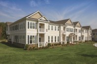 The exteriors of the nine separate buildings were designed to capture the intimacy of single-family homes, so the structures were kept to two stories and given residential details such as pedimented roofs, porticos, shutters, balconies, and stone bases.
