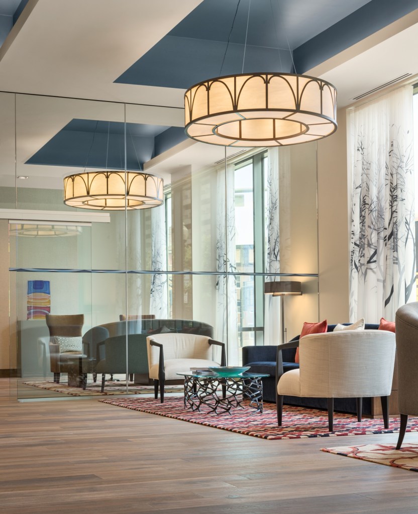 A multilevel lobby with glass lends a modern feeling to One Canal but celebrates the old, too, with a mural about the Middlesex Canal, which once bisected the site and served as a major transportation artery for Boston. One wall is lined with granite from the canal's quarry.