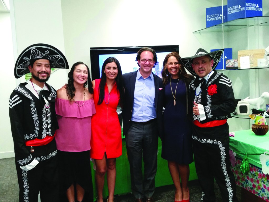 Toby Bozzuto, CEO at Bozzuto Group, pictured fourth from left, poses with employees during a Vida at Bozzuto event celebrating Latin culture.