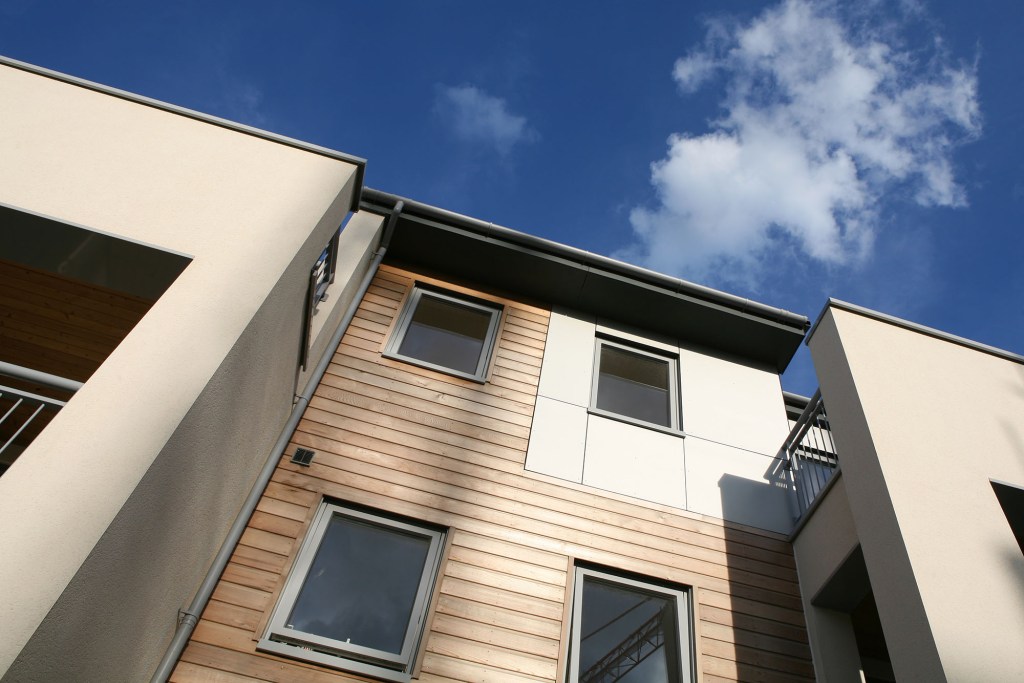 Smart modern low-rise apartments with softwood and aluminium cladding.