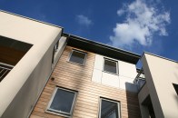 Smart modern low-rise apartments with softwood and aluminium cladding.