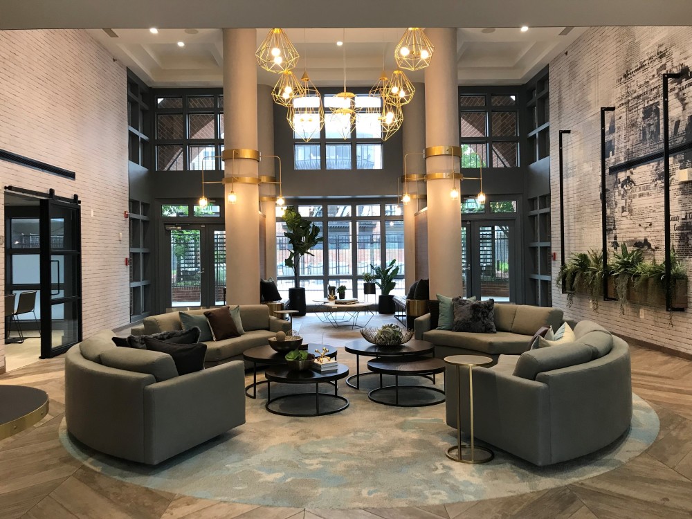 The clubhouse at The Citizen at Shirlington Village in Arlington, Va., was updated with upscale furnishings and an urban-inspired design aesthetic, including brushed brass lighting fixtures and oversized newsprint art.