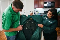 Navy veteran and Valet Giving Hero recipient Andrew Durbin receives his laundry delivery from Valet Living associate Valerie Hernandez.