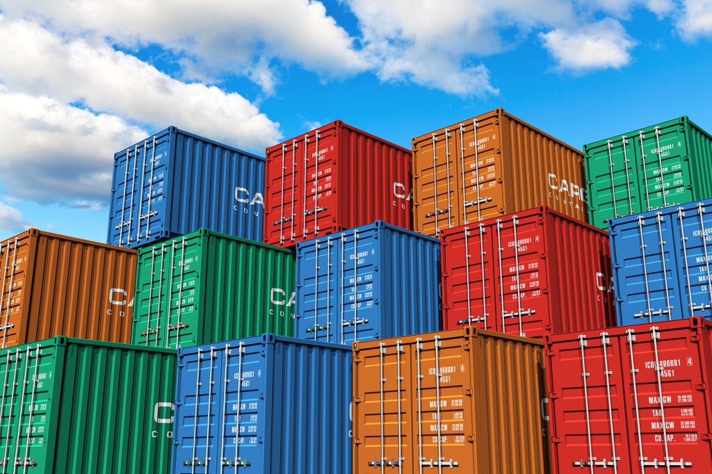 Stacked cargo containers in storage area of freight sea port terminal