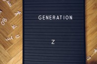 Isolated blackboard on the floor with a millennial message. Generation z ready to change the course of the world. Better and bright tomorrow. Ecology, concern about environment and technology concept.