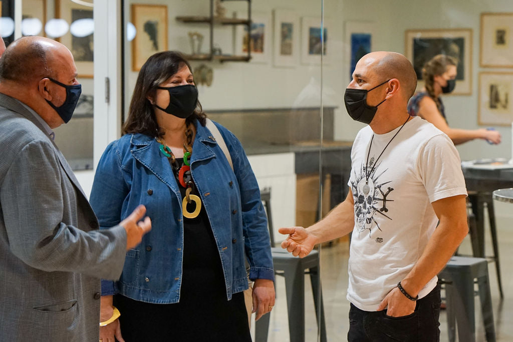 American Landmark Apartments CEO Joe Lubeck and corporate liaison Gladys Margarita Diaz talk with artist in residence Artem Mirolevich.