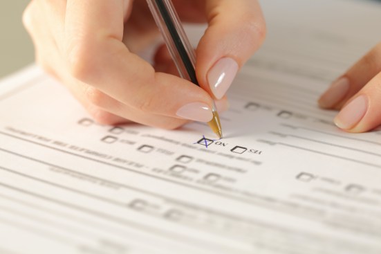 Close up of woman hands filling form crossing no checkbox