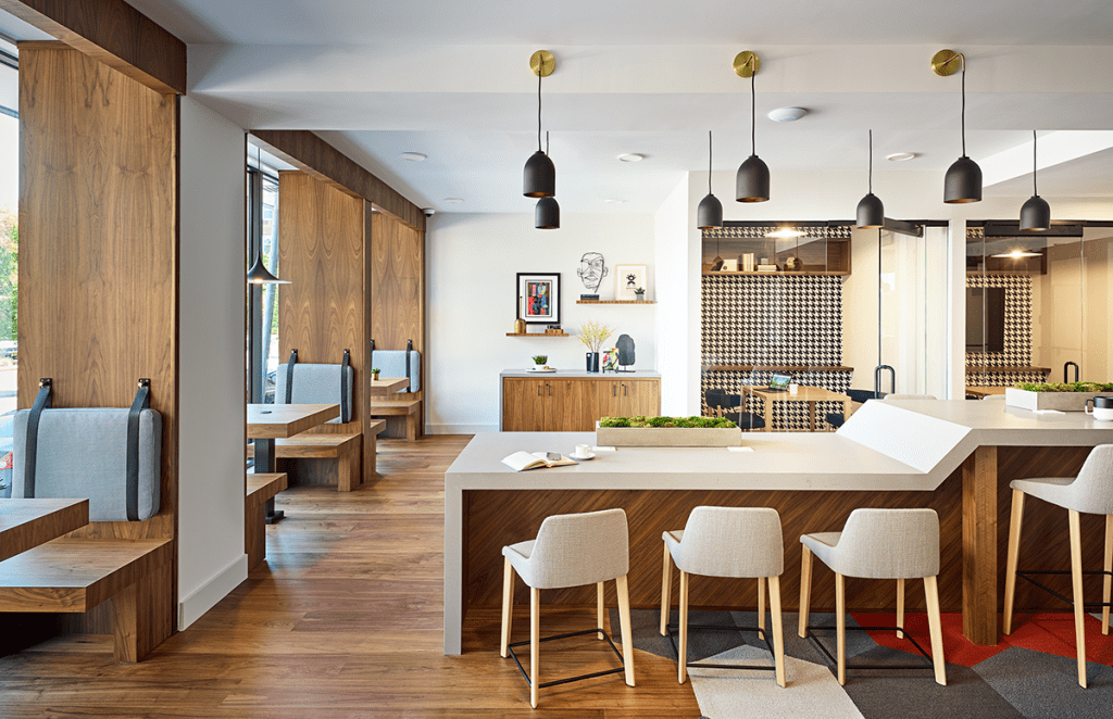 Courtesy of Mary Cook Associates // Mary Cook Associates designed the interiors for the coworking lounge at Dey & Bergen, a rental community in Harrison, N.J., which features a variety of private and semi-private nooks and ergonomic workstations offering a mix of traditional desk seating and counter-height alternatives.