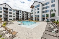 Amenities at NOVEL Cary in Cary, North Carolina, feature a saltwater pool with cabanas as well as a hammock lawn.