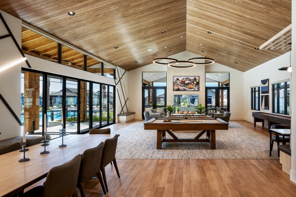 A room with pool tables and chairs