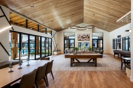A room with pool tables and chairs