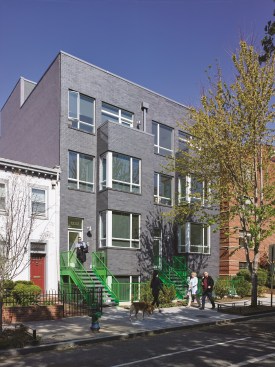 The infill duplexes at 1232–1234 10th St. are finished in manganese iron spot brick in the front (shown) and weathered zinc in the back.