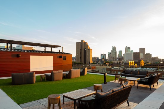 A large glass movable wall in Rafter's clubroom opens up to a rooftop sundeck, with dedicated areas for dining and gaming, as well as an outdoor theater.