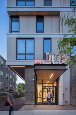 1943 Dot Ave is designed to bridge the scale and proportion of the neighborhood's existing three-story apartment buildings, known as triple-deckers, and the newly constructed larger-scale multifamily developments.