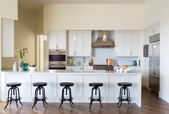 An in-unit kitchen echoes the creamy colors used on the building's elevation.