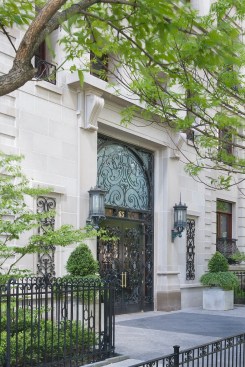 Natural masonry in an earthy tone, such as the limestone entry portico at 65 E. Goethe in Chicago, sets a calm, quiet tone.