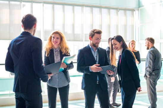 Business people standing and talking in the corridor of a business center