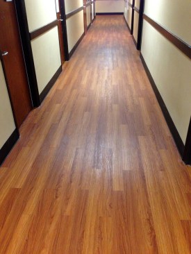 Cherry vinyl-plank flooring pushes a unified look to the edges while providing the durability required in student housing.