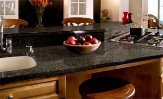 Get the look of natural quartz with the practicalities of a solid surface countertop. Samsung's newest line, Tempest, offers 10 colors: horizon, shell, rattan, caraway, russet, cinnamon, sierra, dapple, milestone, and coffee bean. Plus Staron offers an additional 62 colors in its solid surface line. The product is a 100 percent acrylic surface composed of high-performance acrylic resin, organic fillers, and pigments.
Cost:  $60 to $65 per square foot, fabricated and installed 
ROI:  Solid surfaces, unlike stone, offer nonporous, hygienic properties because the impenetrable seams prevent unwelcome germs and mildew. The material can be fabricated into configurations nearly impossible with stone, including fully covered backsplashes and seamless integration with sinks and bowls.