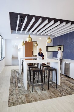 This functional kitchen space designed by FOX Architects gives workers a casual place to get to know one another when they need a break from their work.