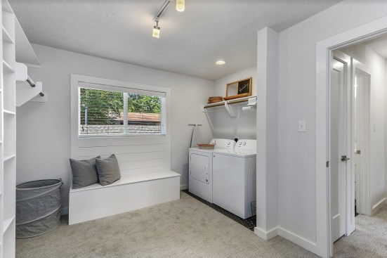 The development team transformed each unit's second bedroom into an oversized closet with built-ins, a storage bench, and a washer and dryer.