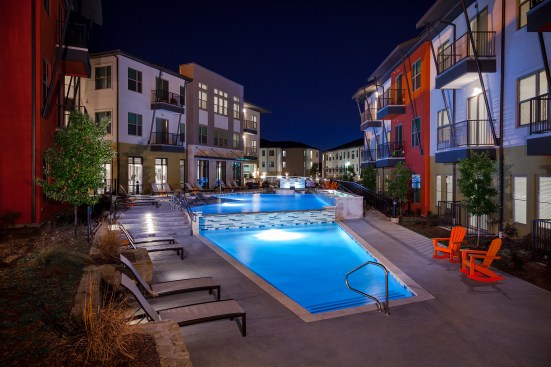 Modular construction doesn't have to equal a lack of high-end amenities. LBJ Station in Dallas offers residents a resort-style pool featuring several in-pool seating areas for lounging that lends a luxury feel.