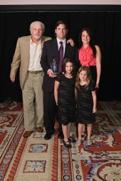 David J. Adelman, president and CEO of Campus Apartments, accepts his Executive of the Year award with his family at the awards gala luncheon on October 13 in Las Vegas.