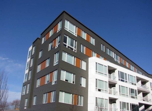 Fiber-cement siding allows for mitered corners, giving a building a volumetric feel.