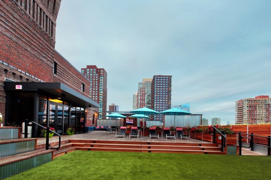A rooftop deck at Modera Lofts in Jersey City, N.J. Mill Creek redeveloped the historic industrial property incorporating nostalgic touches such as 12-and-a-half-foot ceilings, exposed brick, large windows, and wood beams and columns. Modern features include a 24-hour concierge, conference rooms, movable islands, and views of Manhattan. Even workforce housing is available at the smoke-free community.