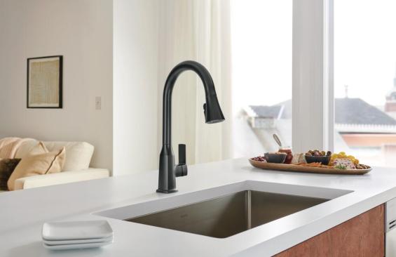 A black faucet on a white countertop