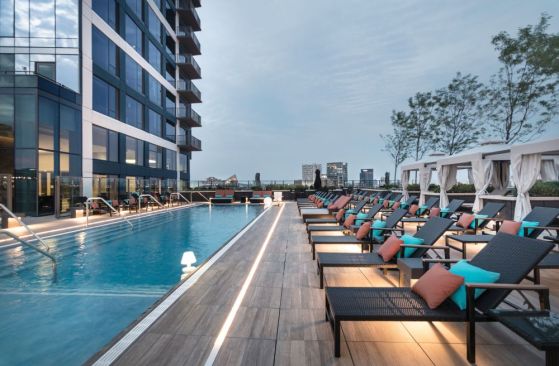 The seventh-floor amenity deck includes a landscaped park, an outdoor kitchen area, and a pool that overlooks Baltimore's Inner Harbor.