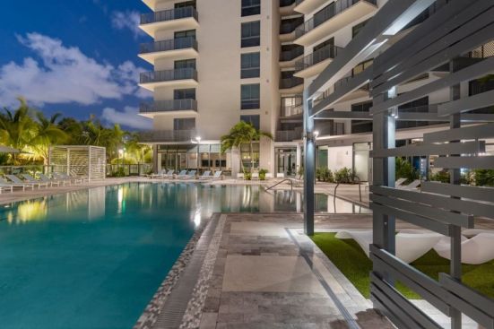 At Remi on the River in Miami, the resort-style pool is complete with an array of seating options and views of the Miami River.