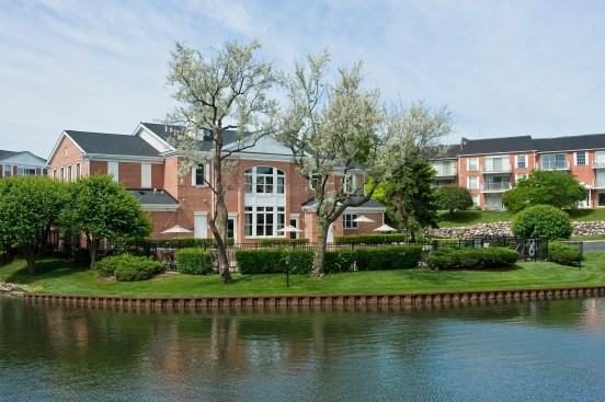 clubhouse, landscaping, pond, water feature
