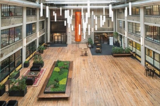 The building's immense, three-story, central atrium became a light-filled shared space once greenhouse glass replaced its damaged roof. New, large windows on three sides bring light into the surrounding offices.