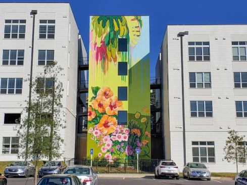 Artist Lacey Longino created this mural, which greets residents as they enter from the parking area.