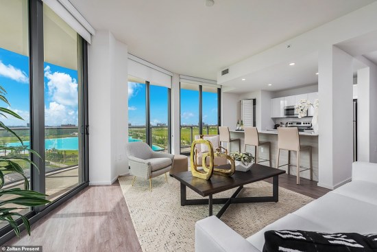 An apartment interior with a view of the Crystal Lagoons amenity at Sole Mia in Miami.