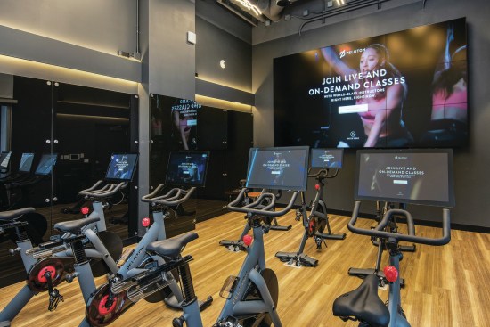 Residents at Bozzuto’s Spoke apartments in Chicago can take virtual spin classes with the property’s provided Peloton bikes.