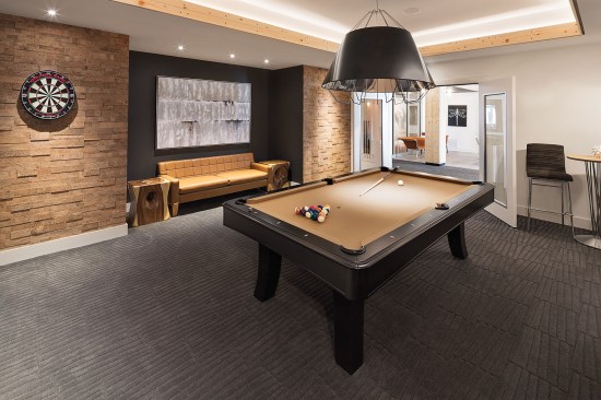 The team made the residential units at The Edison fairly small to put the focus on what millennials care about most: a variety of large-scale amenities, including a billiards room/lounge.
