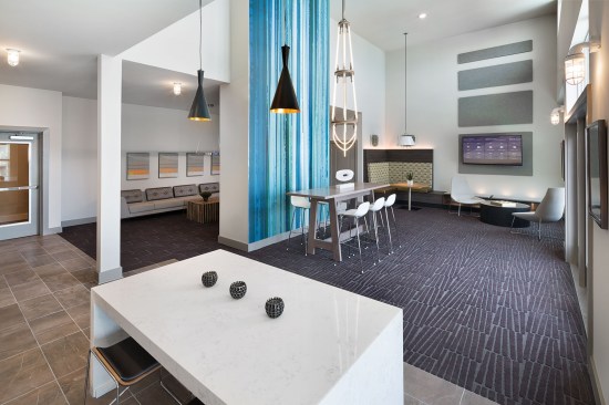 Two clubrooms give tenants a place to escape and socialize, work, or even cook communally.