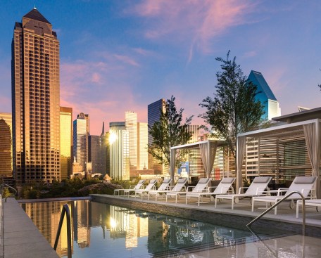 Residences at Park District in Dallas offers an array of luxury amenities, including an open-air escape on the sixth level with an infinity-edge pool, social lounge areas, private cabanas, fire pits, and grilling stations.