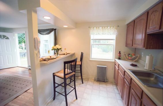 Hackensack Gardens in New Jersey is one of the 219 communities that Home Properties has acquired and repositioned since its IPO 18 years ago. The 1940s-era property (“before” and “after” kitchen photos pictured) was a Class C asset in a Class B area. Older properties like this 198-unit community tend to have closed floor plans, so Home usually removes the kitchen walls to open up the units.
