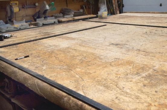 The 1/2-in.-thick precast wall panels were made in a shop setting. Steel bulkheads were placed on top of a large texture mat to vary panel sizes.

