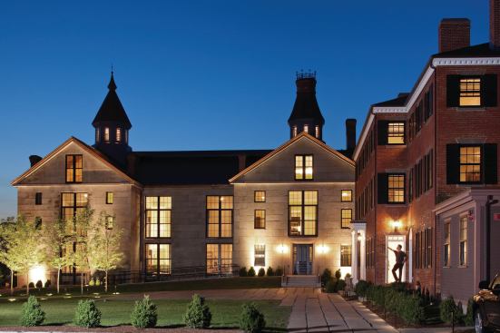The former jail glows at night with its large windows and landscape lighting. 